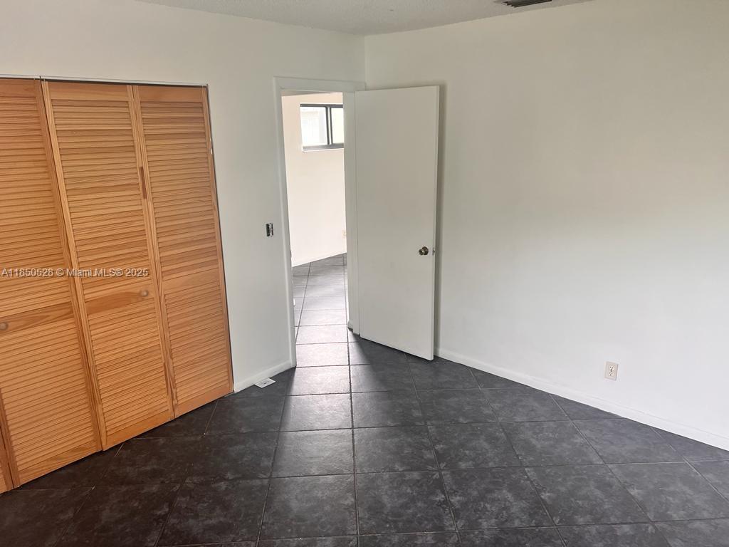 17 Crossings Circle, Unit E Boynton Beach, FL 33435 - Photo 20 of 20 a view of an empty room with brick walls