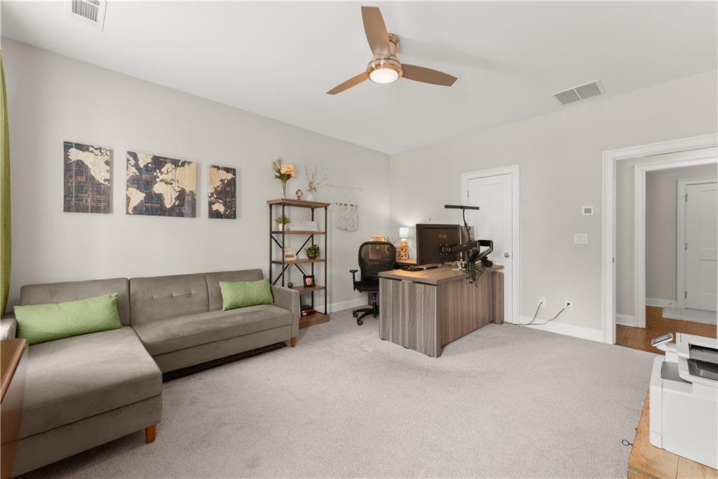 3206 Ridge Towne Place Duluth, GA 30096 - Photo 29 of 42 a living room with furniture and a flat screen tv