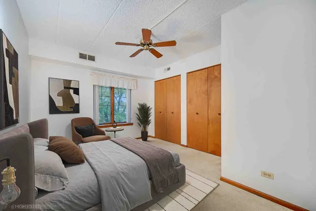 a bedroom with a bed and a painting on the wall