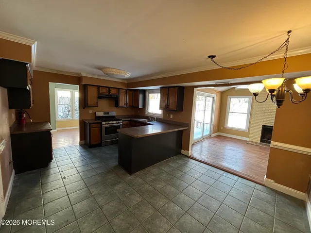 a large kitchen with a wooden floor and cabinets