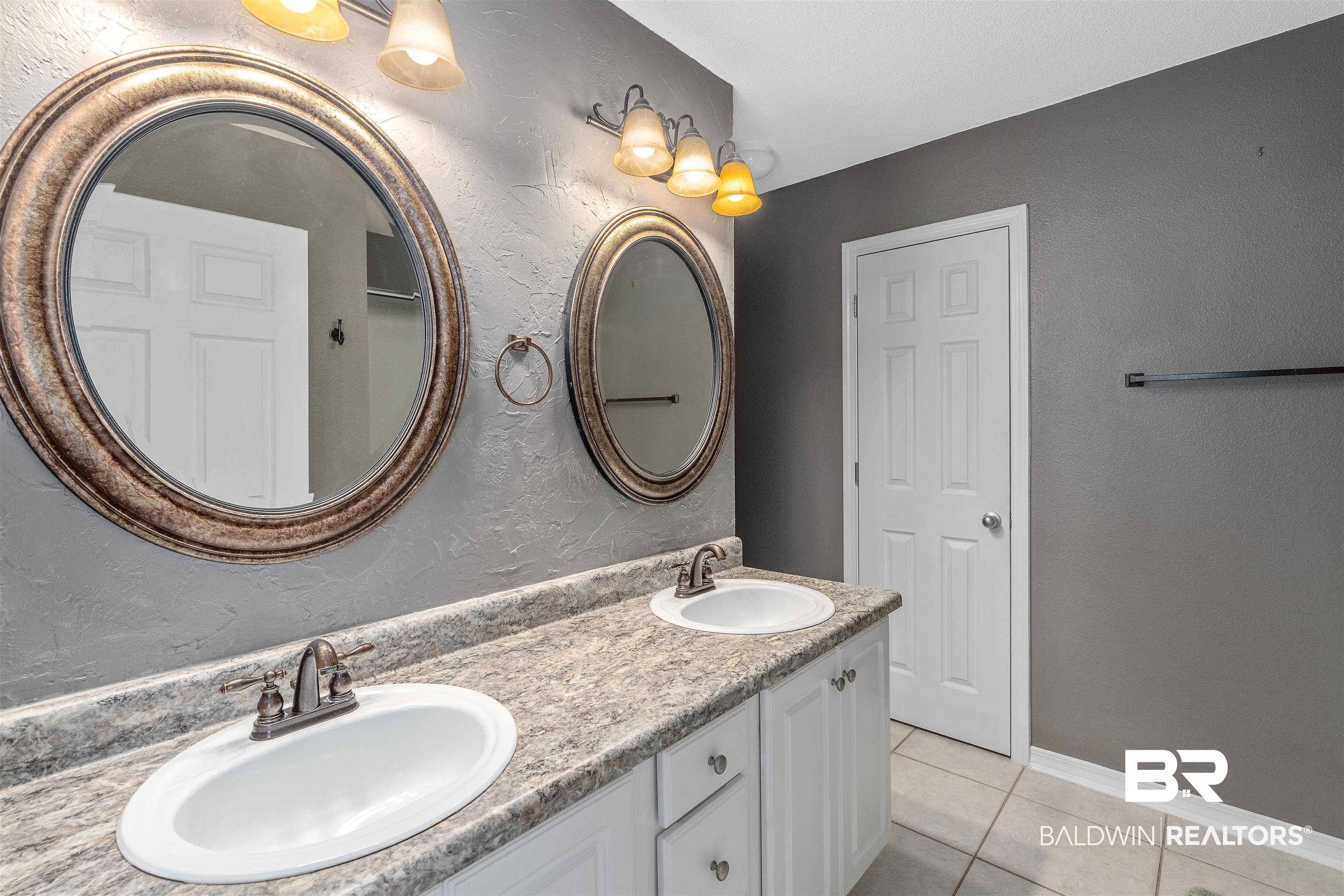 11097 Pontchartrain Loop Daphne, AL 36526 - Photo 19 of 28 Bathroom featuring tile patterned flooring, double vanity, and a textured wall