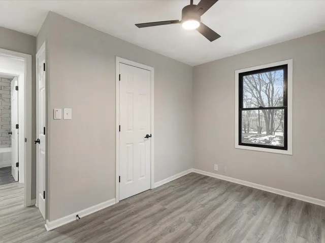 wooden floor in an empty room with a window