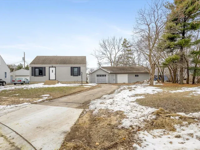 a view of a house with snow on the road