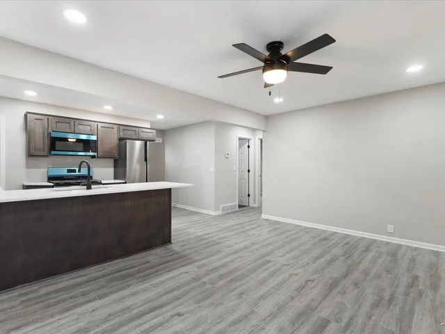 a view of kitchen with microwave and wooden floor