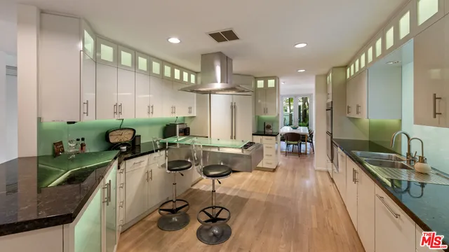 a kitchen with stainless steel appliances granite countertop a sink and cabinets