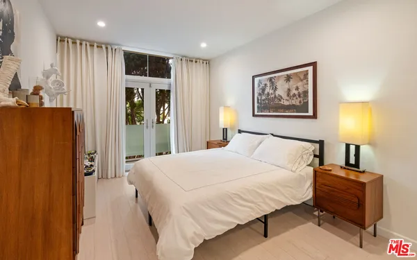 a bedroom with a bed and a lamp