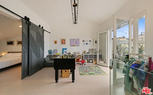 a balcony with wooden floor and outdoor seating