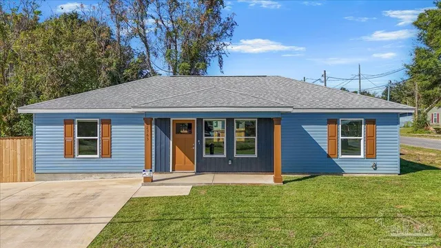 a front view of a house with a garden