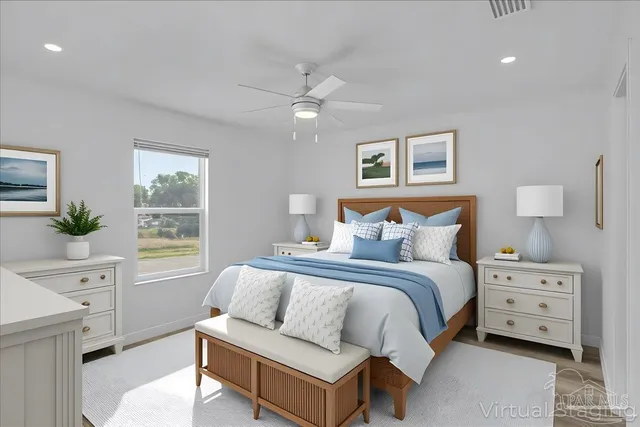 a bedroom with a bed and a dresser with a potted plant
