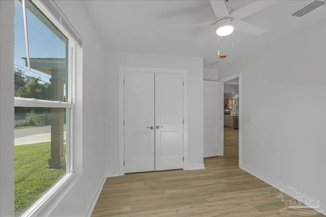 a view of an entryway with wooden floor and door