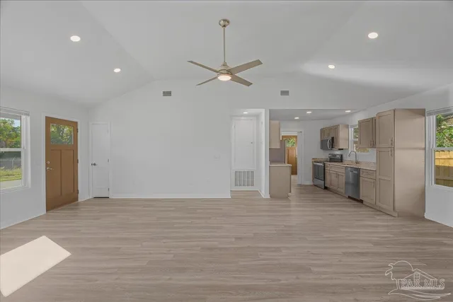 a view of a kitchen with a sink and a refrigerator