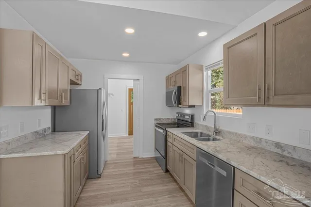 a kitchen with a sink and a refrigerator