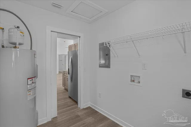 a view of a hallway with wooden floor and closet