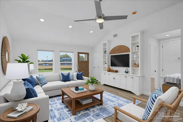 a living room with furniture a rug and a flat screen tv