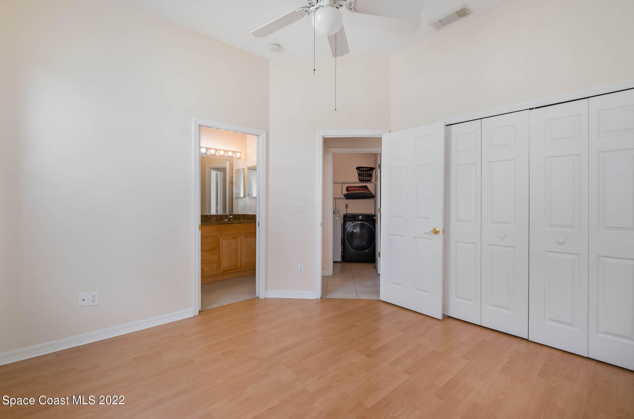 2364 Addington Circle Rockledge, FL 32955 - Photo 14 of 22 an empty room with closet and a chandelier fan
