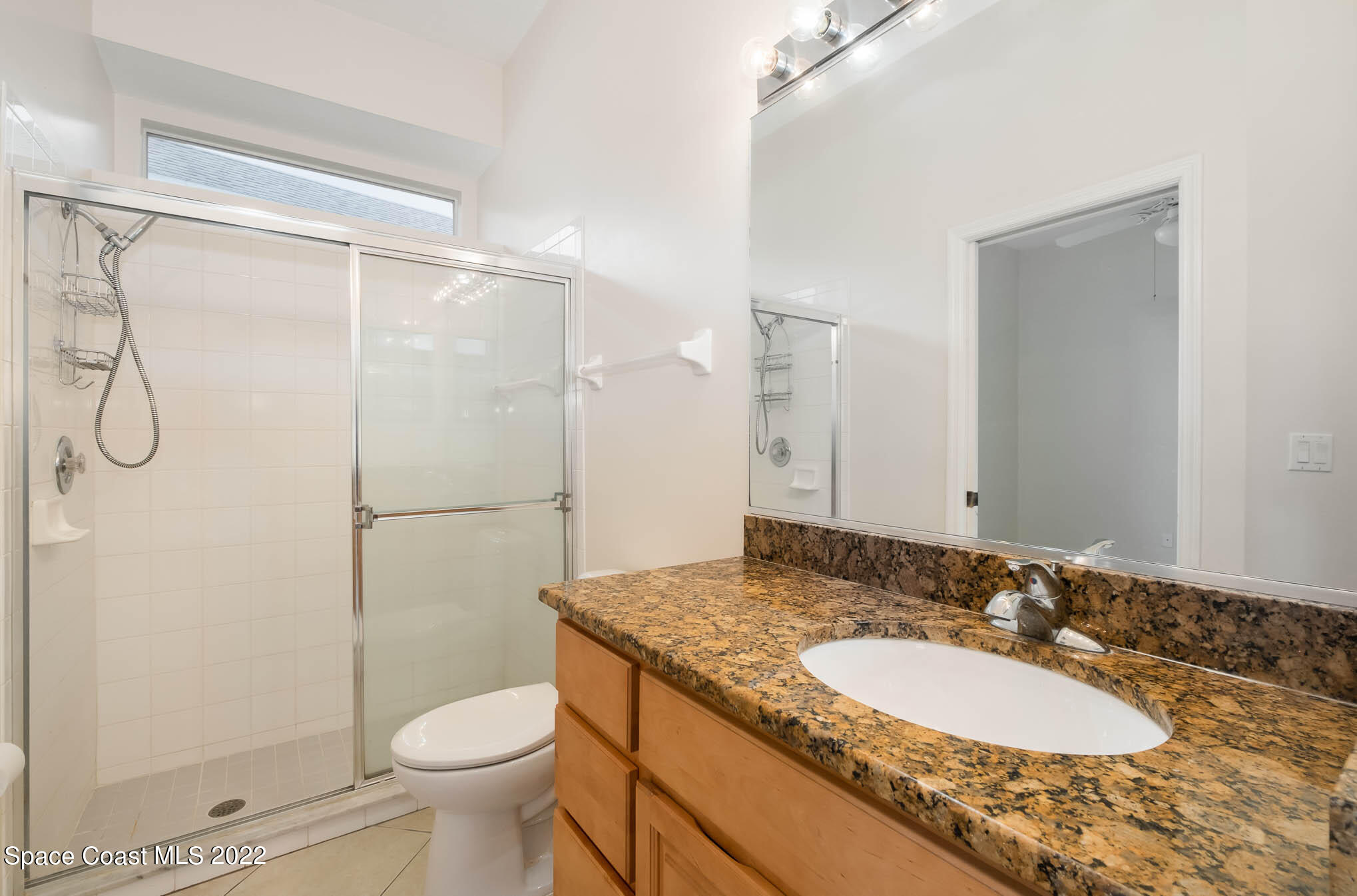 2364 Addington Circle Rockledge, FL 32955 - Photo 16 of 22 a bathroom with a granite countertop sink toilet and shower
