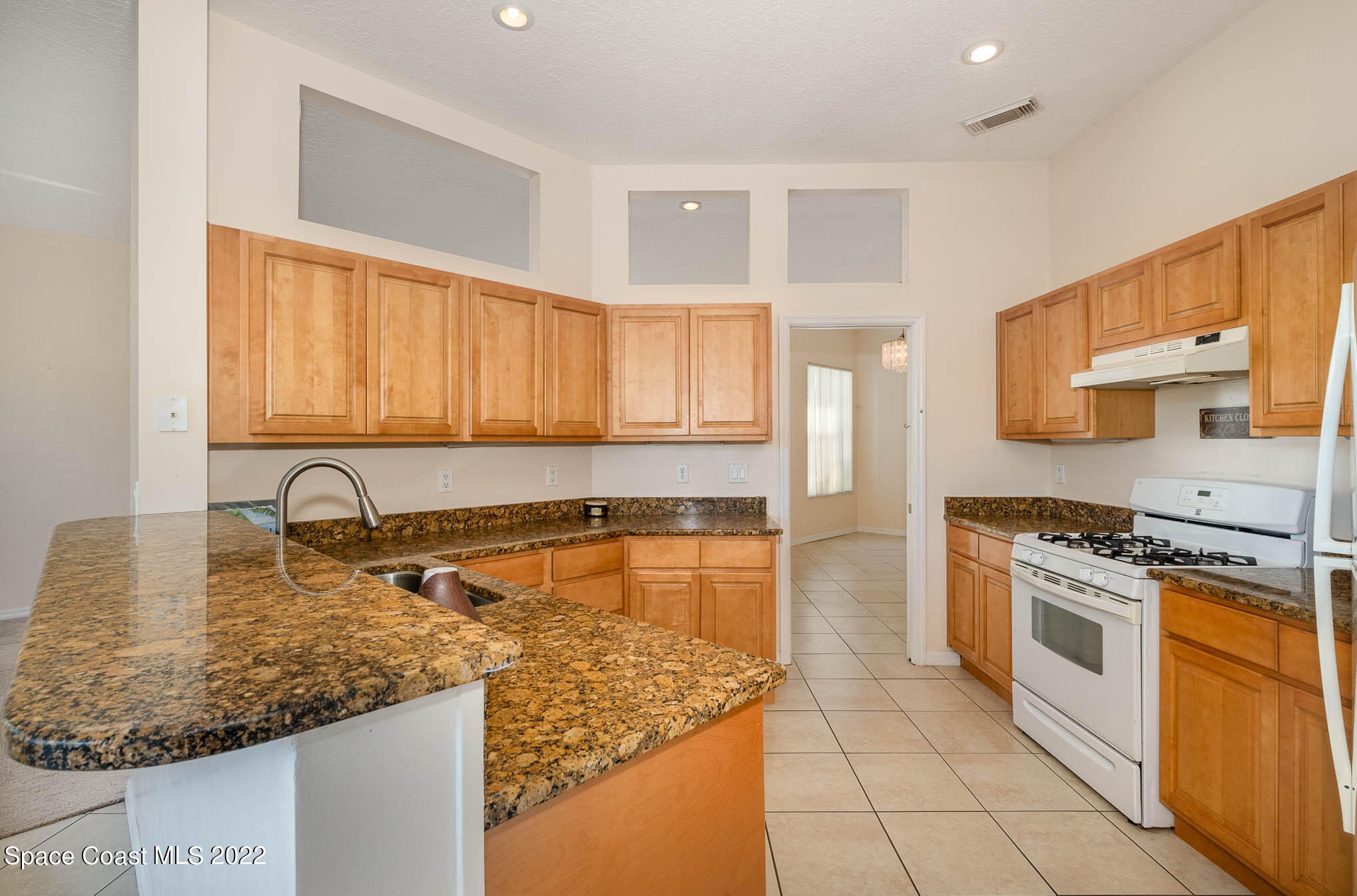 2364 Addington Circle Rockledge, FL 32955 - Photo 2 of 22 a kitchen with stainless steel appliances granite countertop a sink stove and cabinets