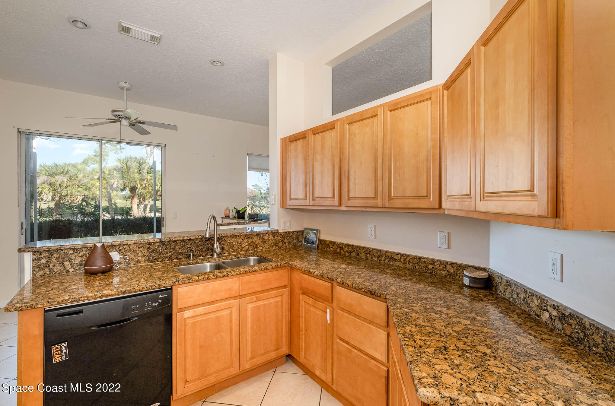 2364 Addington Circle Rockledge, FL 32955 - Photo 5 of 22 a kitchen with granite countertop sink and cabinets