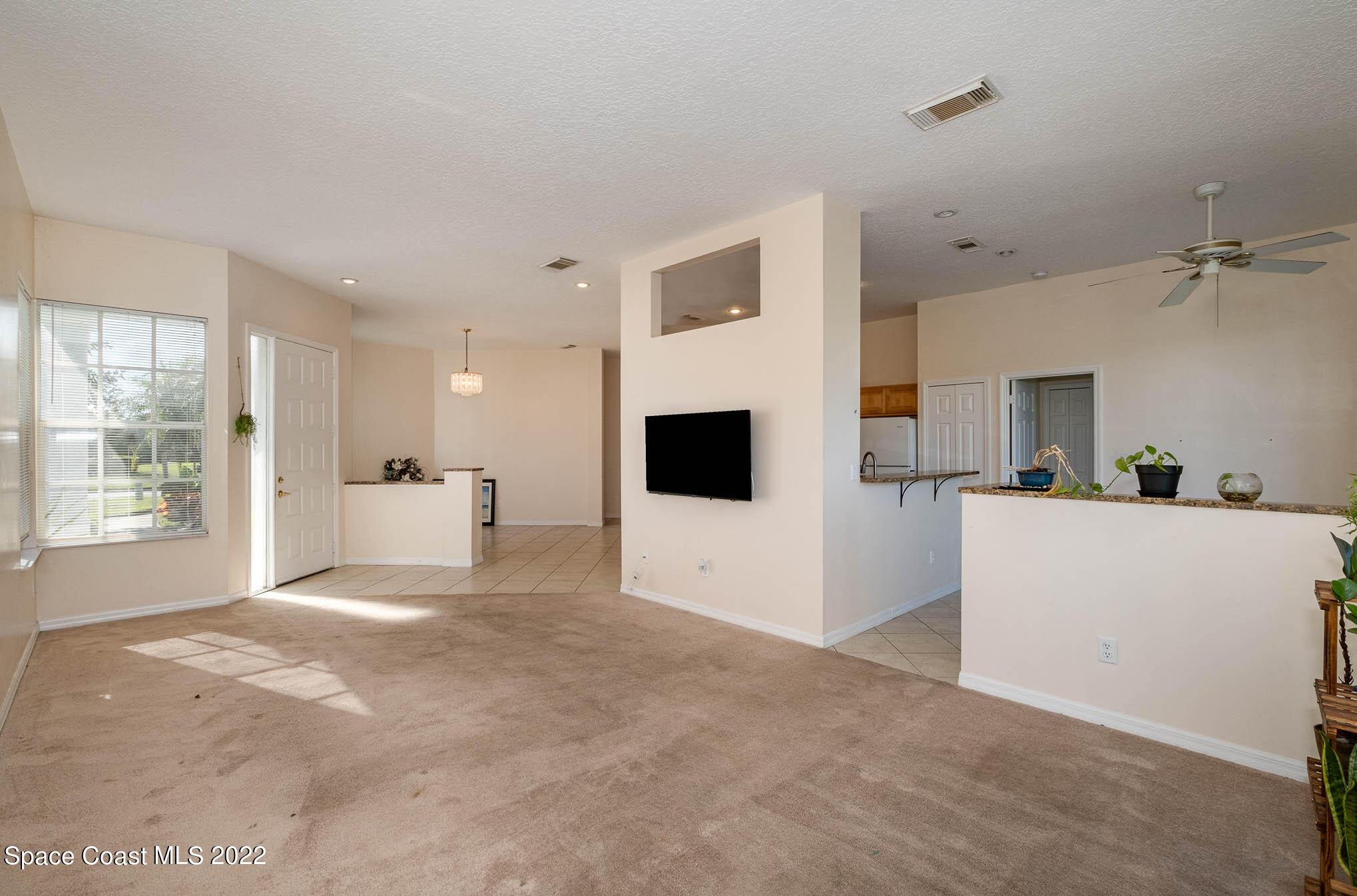 2364 Addington Circle Rockledge, FL 32955 - Photo 6 of 22 a view of a big room with kitchen view and a window