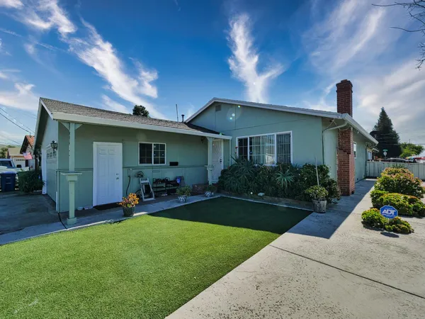 a front view of a house with a garden and patio