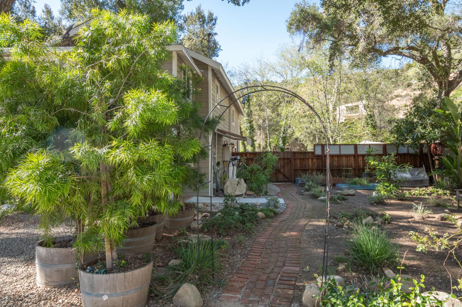 15663 Ojai Road Santa Paula, CA 93060 - Photo 31 of 47 a view of a backyard with potted plants and large trees