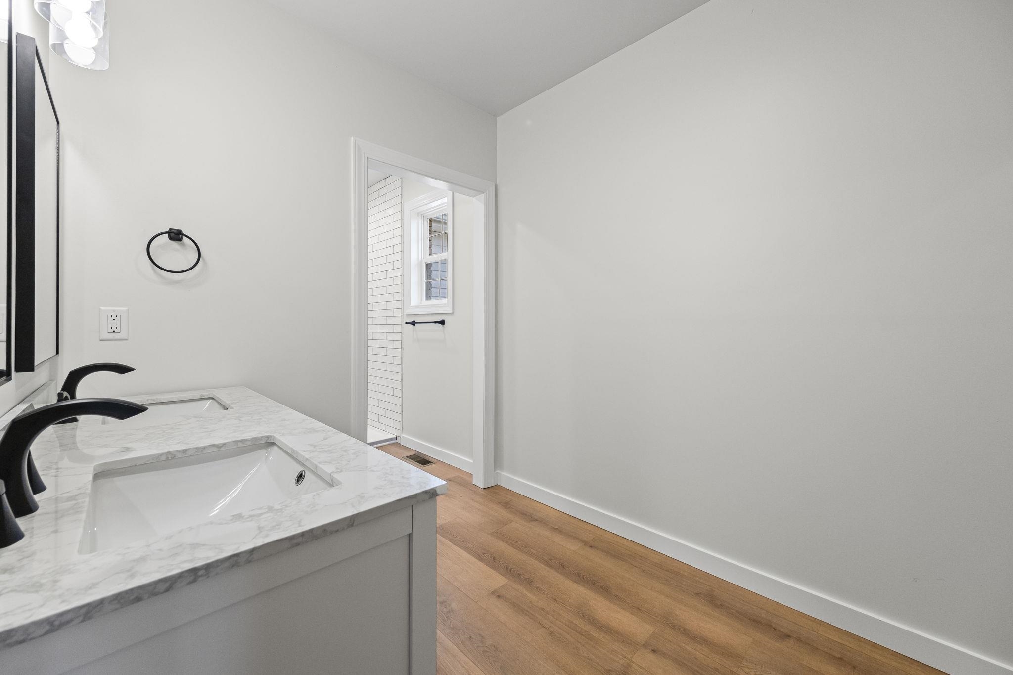 835 Curve Woodville Road Gates, TN 38037 - Photo 16 of 30 Bathroom featuring double vanity and light wood-style floors