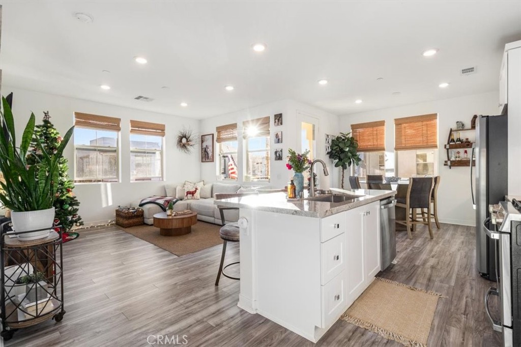 a kitchen with sink refrigerator and dining table