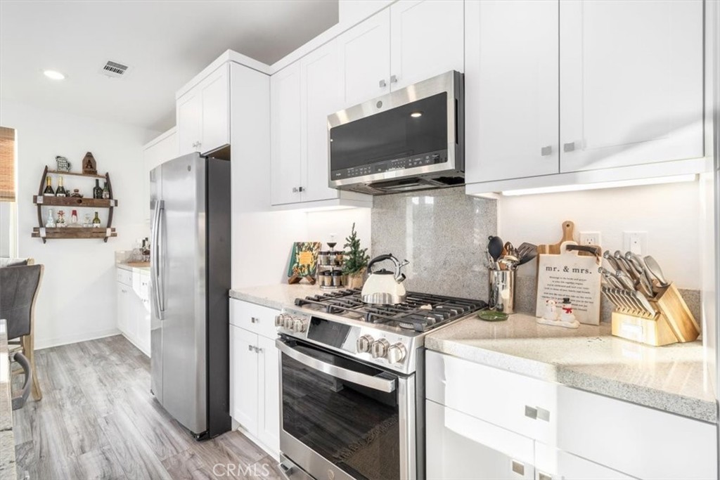 1201 Lasso Way Rancho Mission Viejo, CA 92694 - Photo 14 of 54 a kitchen with stainless steel appliances granite countertop a refrigerator stove and sink