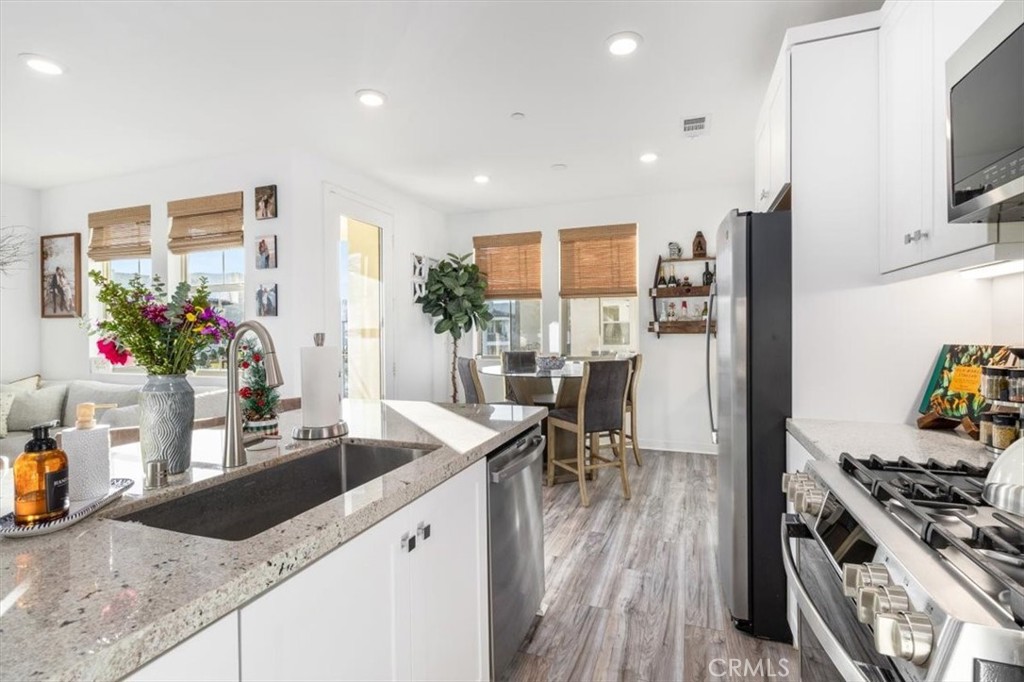 1201 Lasso Way Rancho Mission Viejo, CA 92694 - Photo 15 of 54 a kitchen with granite countertop a sink stove and refrigerator