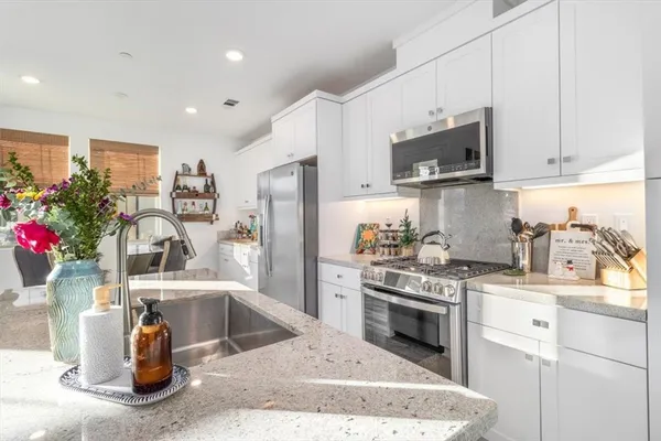a kitchen with sink and cabinets