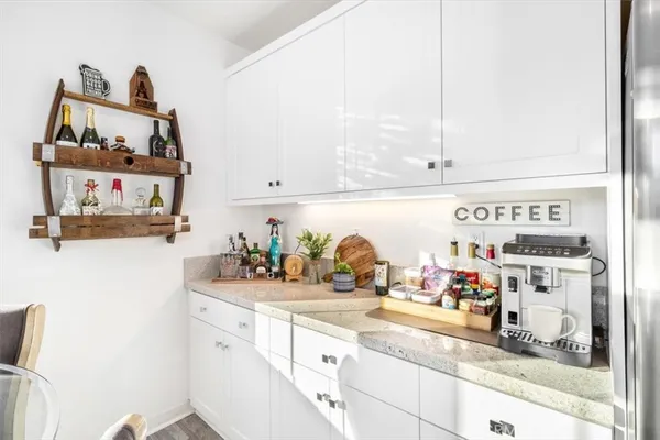 a kitchen with stainless steel appliances kitchen island granite countertop a dining table and chairs