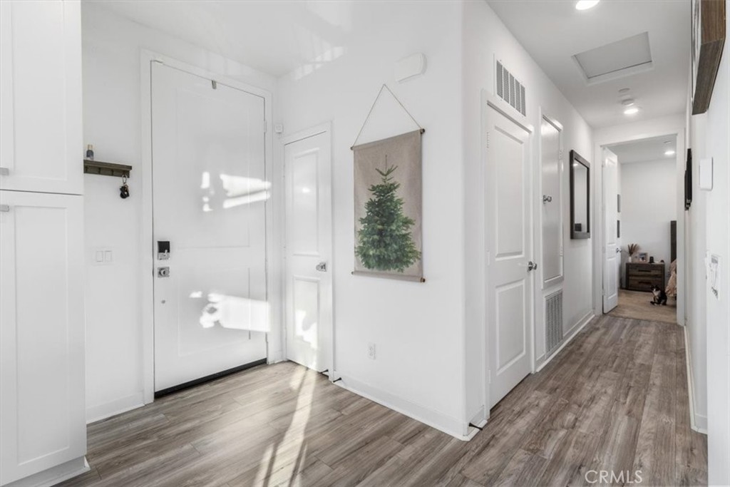 1201 Lasso Way Rancho Mission Viejo, CA 92694 - Photo 18 of 55 a view of a hallway with wooden floor and a bathroom