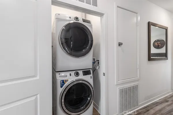 a hallway with wooden floor and couches