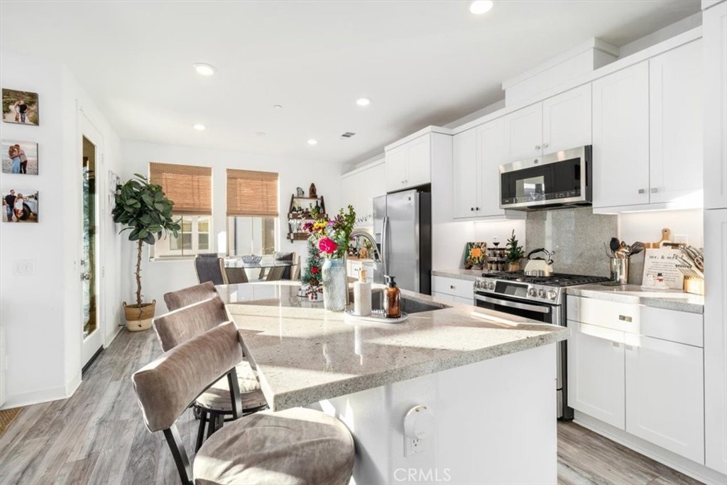 1201 Lasso Way Rancho Mission Viejo, CA 92694 - Photo 2 of 54 a kitchen with stainless steel appliances kitchen island granite countertop a refrigerator and a stove top oven