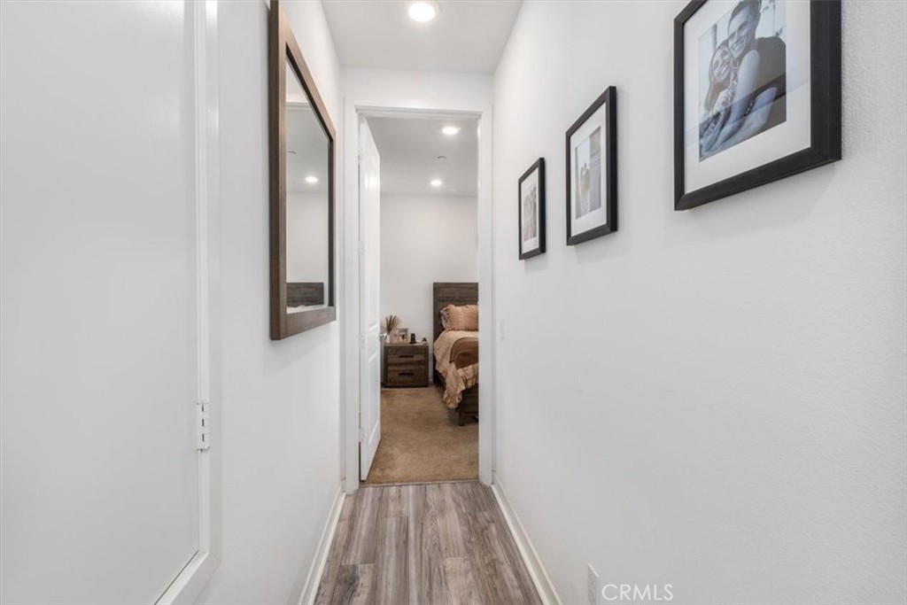 1201 Lasso Way Rancho Mission Viejo, CA 92694 - Photo 21 of 54 a hallway with wooden floor and couches