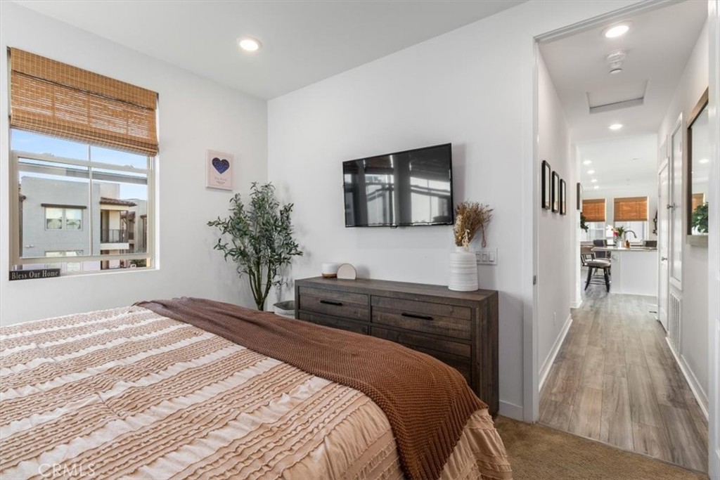 1201 Lasso Way Rancho Mission Viejo, CA 92694 - Photo 23 of 54 a bedroom with a large bed a flat tv screen and potted plant on the dresser