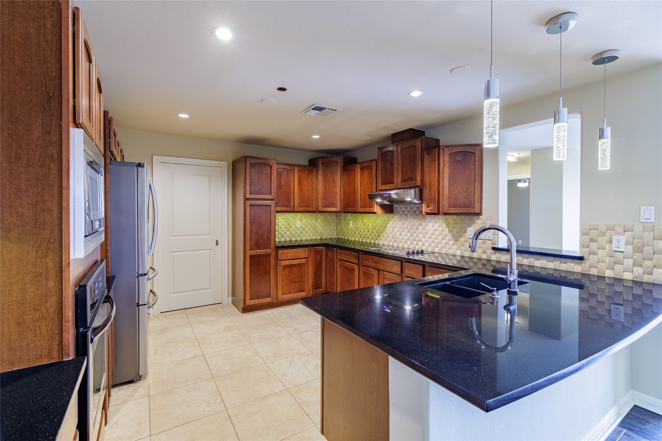 40 North Interstate Highway 35, Unit 6D3 Austin, TX 78701 - Photo 12 of 35 a kitchen with stainless steel appliances granite countertop a sink a stove and a refrigerator