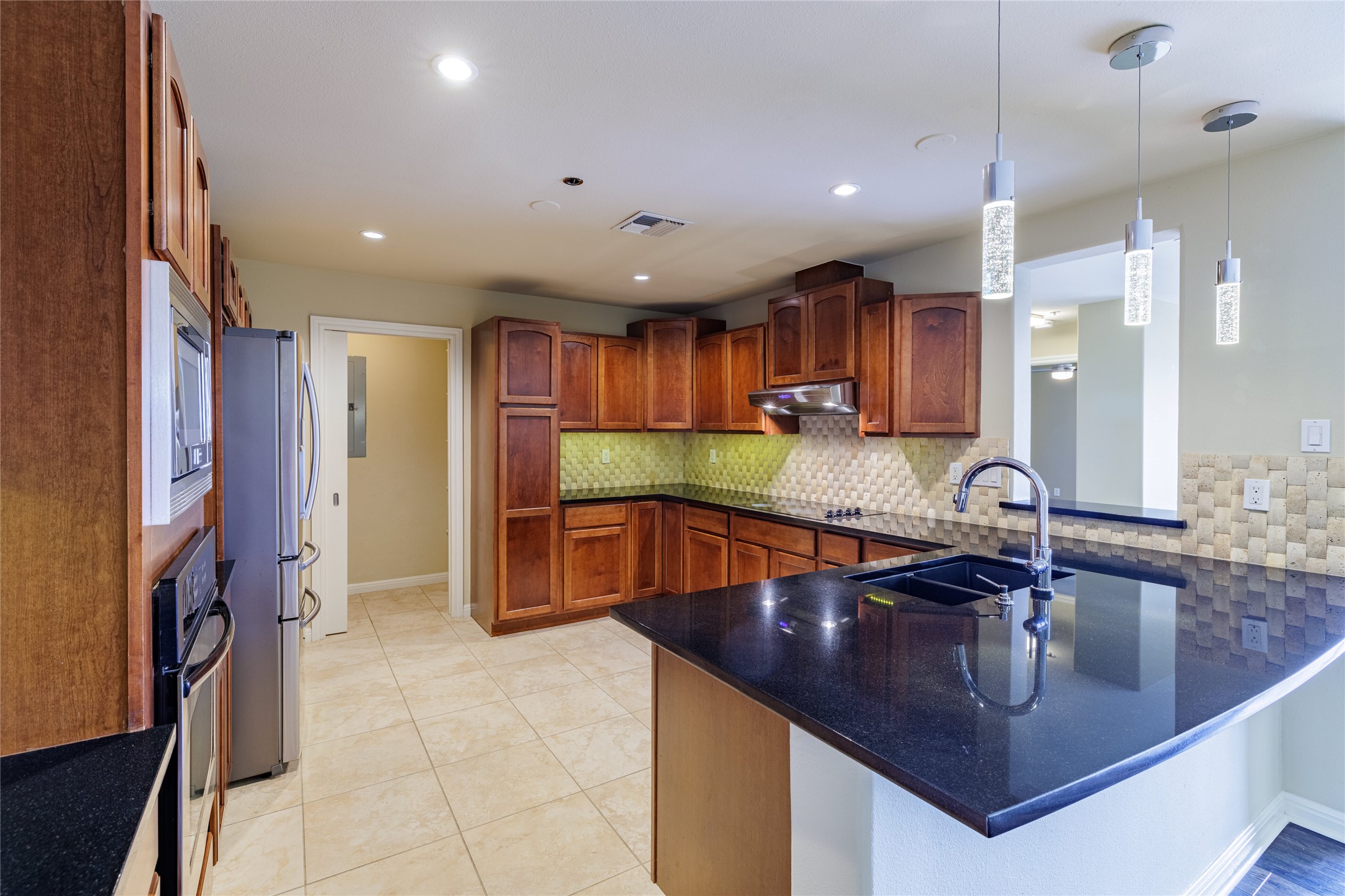 40 North Interstate Highway 35, Unit 6D3 Austin, TX 78701 - Photo 13 of 35 a kitchen with stainless steel appliances granite countertop a sink refrigerator and cabinets
