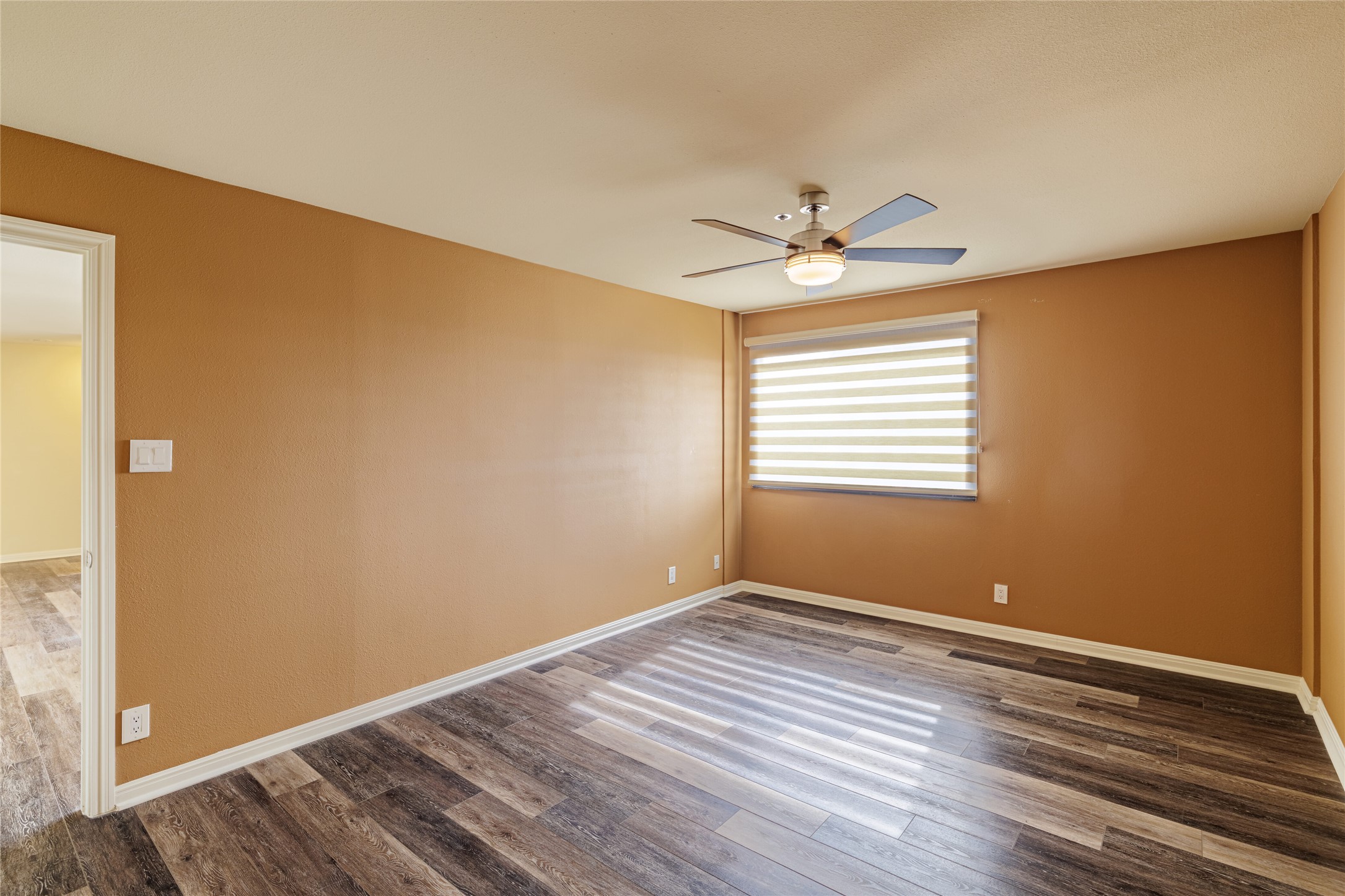 40 North Interstate Highway 35, Unit 6D3 Austin, TX 78701 - Photo 19 of 35 a view of a room with wooden floor and a ceiling fan