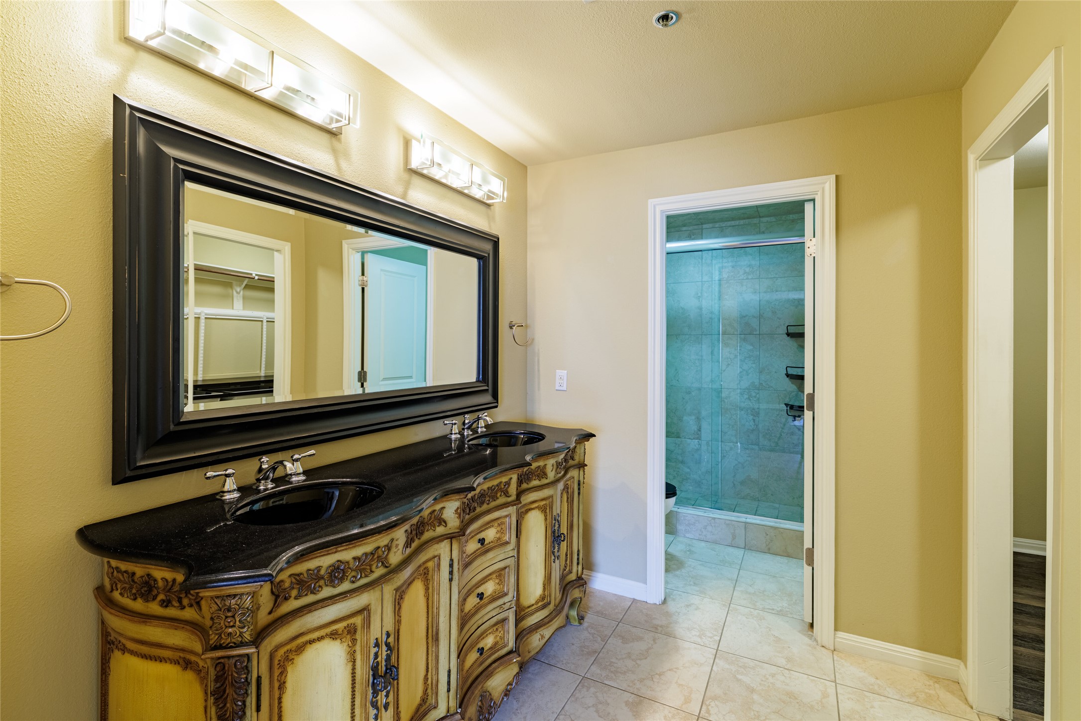 40 North Interstate Highway 35, Unit 6D3 Austin, TX 78701 - Photo 23 of 35 a bathroom with a sink a mirror and a shower