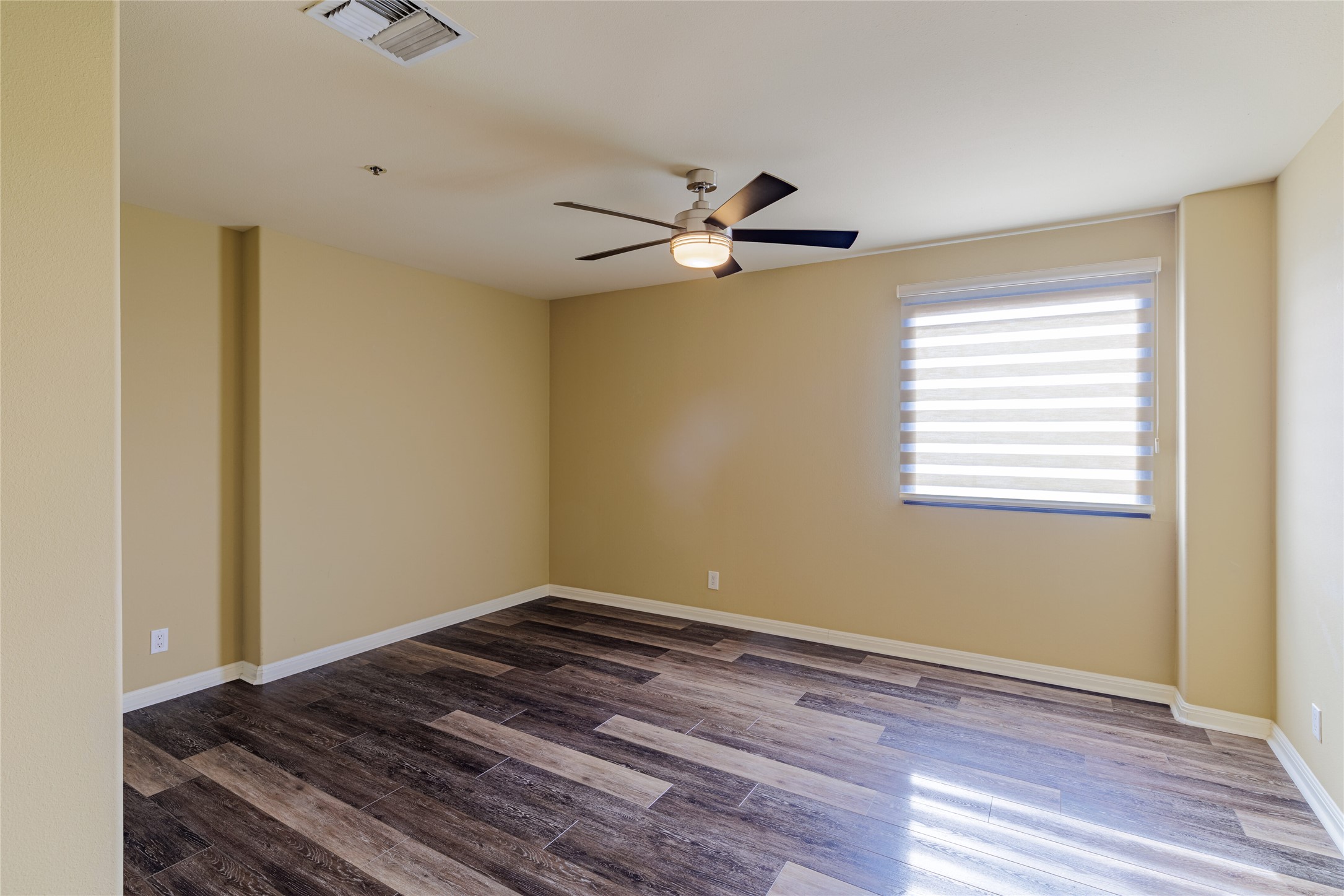 40 North Interstate Highway 35, Unit 6D3 Austin, TX 78701 - Photo 28 of 35 a view of a room with wooden floor and a ceiling fan