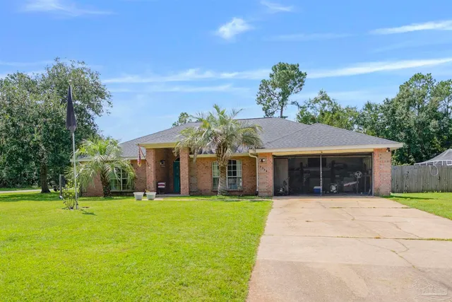 a front view of house with yard and green space