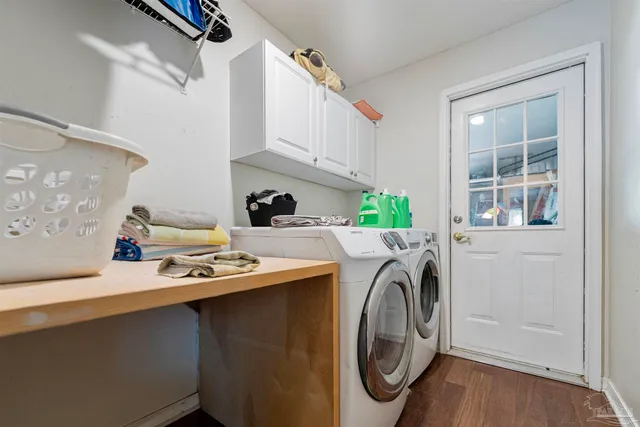 a view of a dining room with furniture a rug and wooden floor