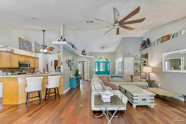 a living room with fireplace furniture and a wooden floor