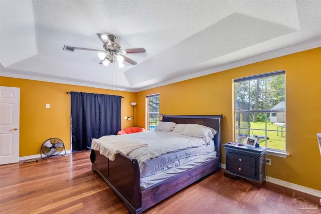 a living room with a bed furniture and a large window