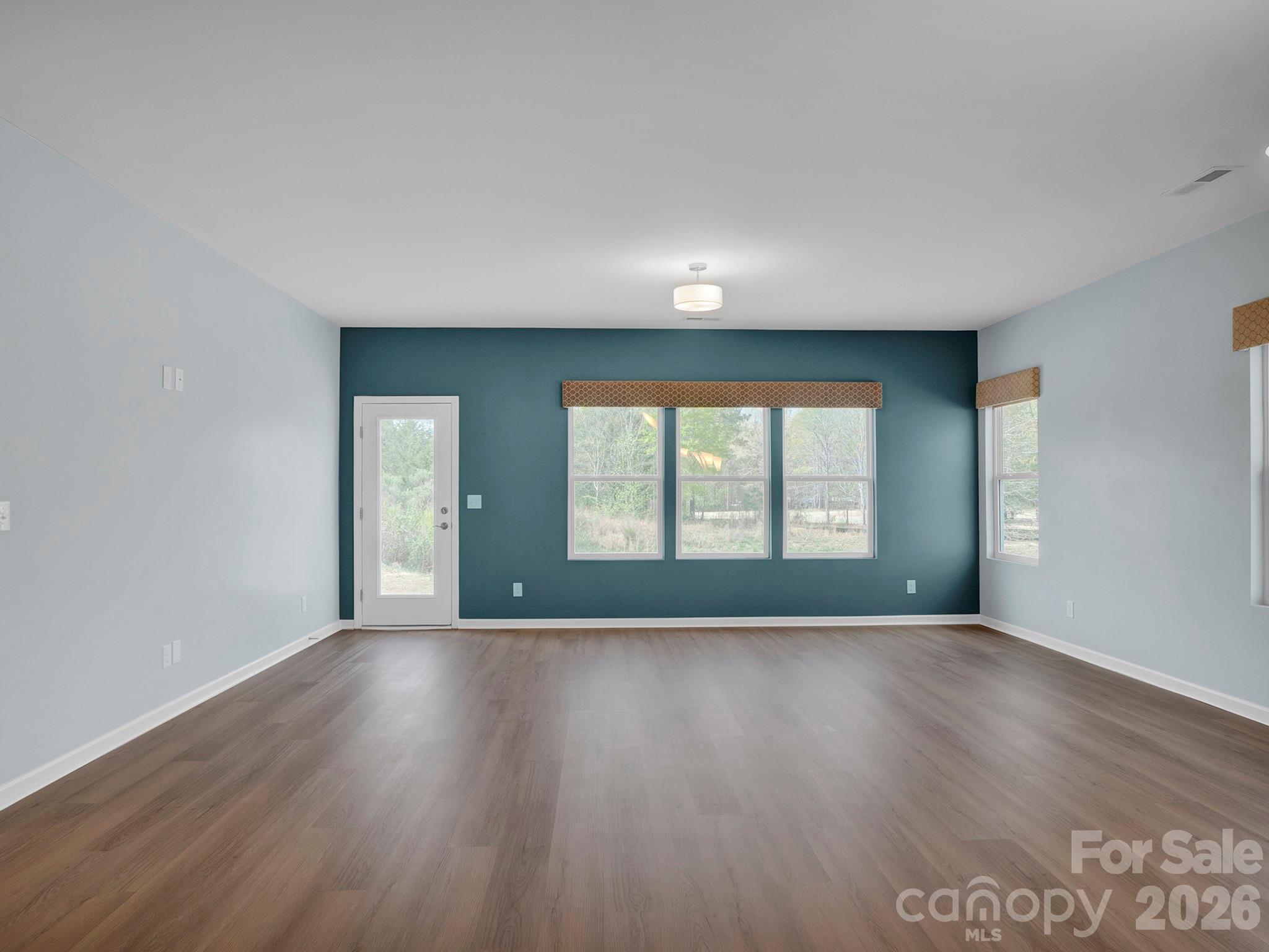 4327 Bent Green Lane Monroe, NC 28112 - Photo 13 of 28 a view of an empty room with wooden floor and a window