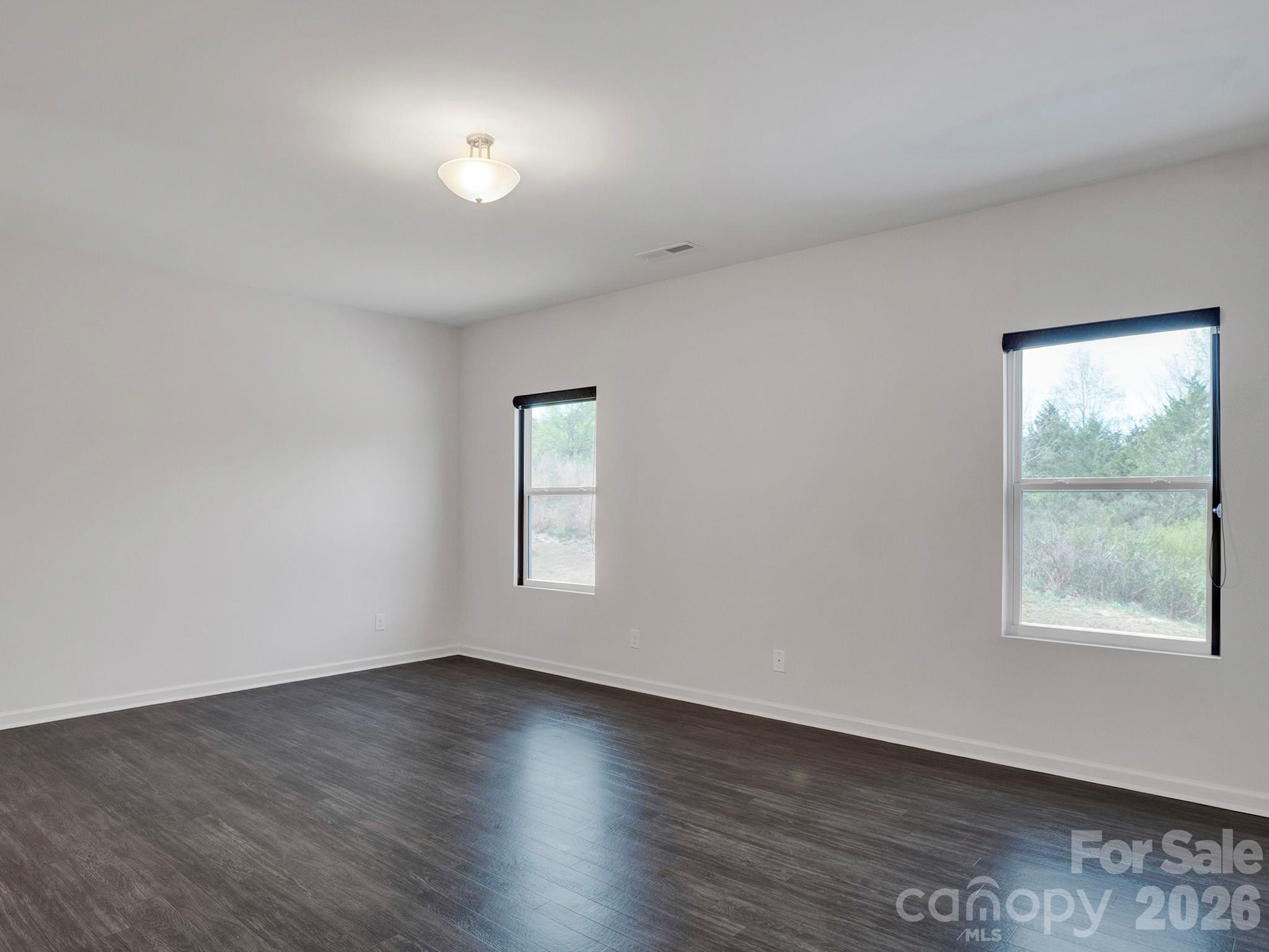 4327 Bent Green Lane Monroe, NC 28112 - Photo 15 of 28 a view of an empty room with wooden floor and a window
