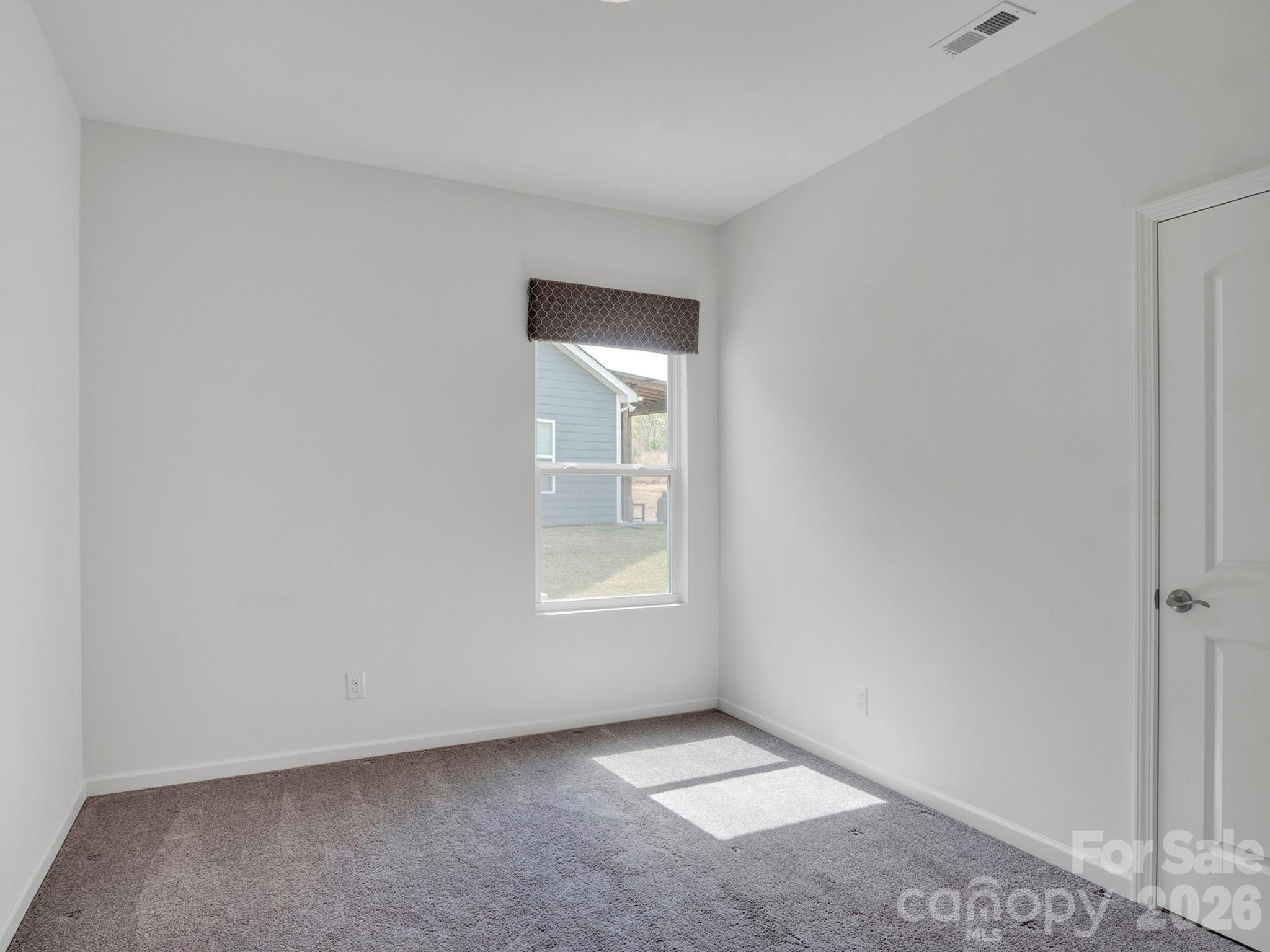 4327 Bent Green Lane Monroe, NC 28112 - Photo 21 of 28 an empty room with windows and closet
