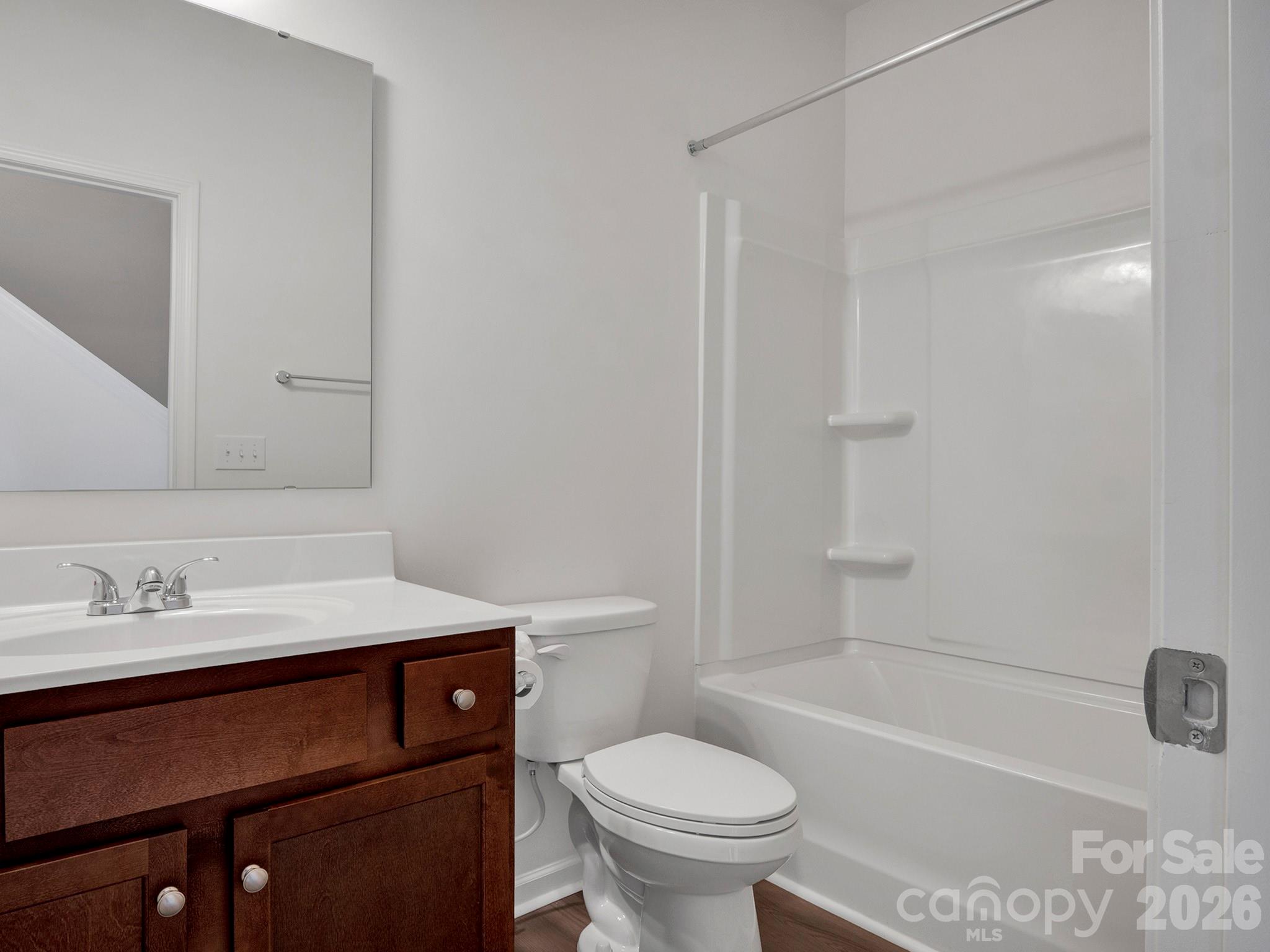 4327 Bent Green Lane Monroe, NC 28112 - Photo 24 of 28 a bathroom with a sink toilet vanity and shower