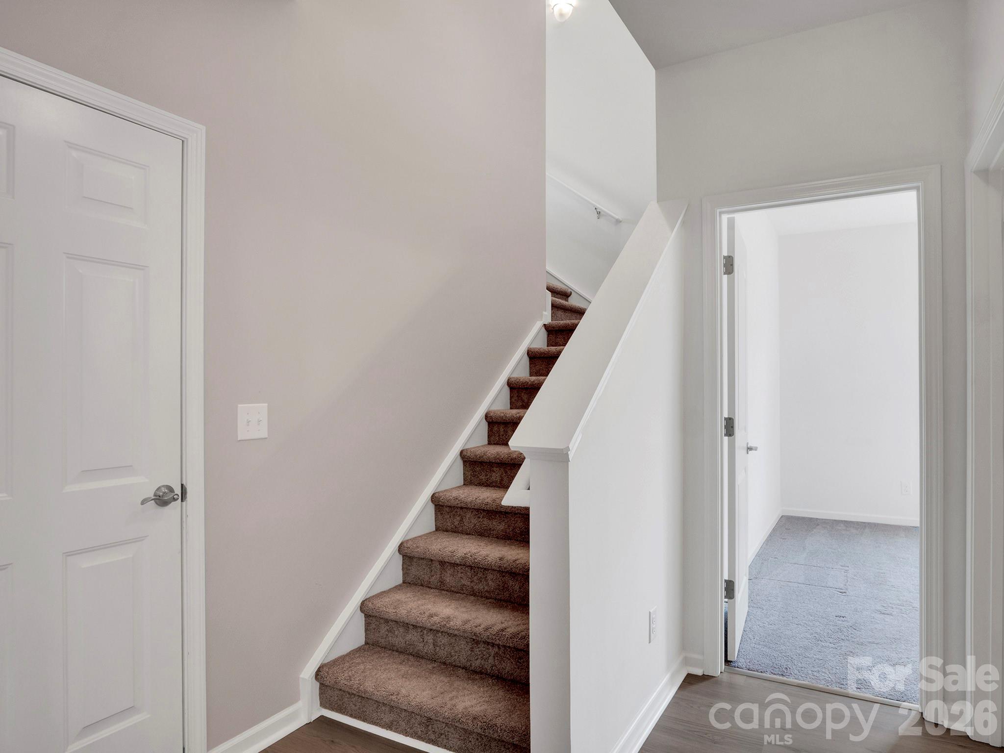 4327 Bent Green Lane Monroe, NC 28112 - Photo 25 of 28 a view of entryway with stairs and wooden floor